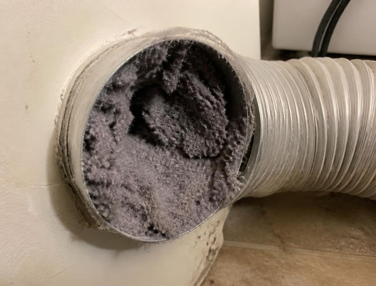 Dryer vent duct clogged with heavy lint buildup